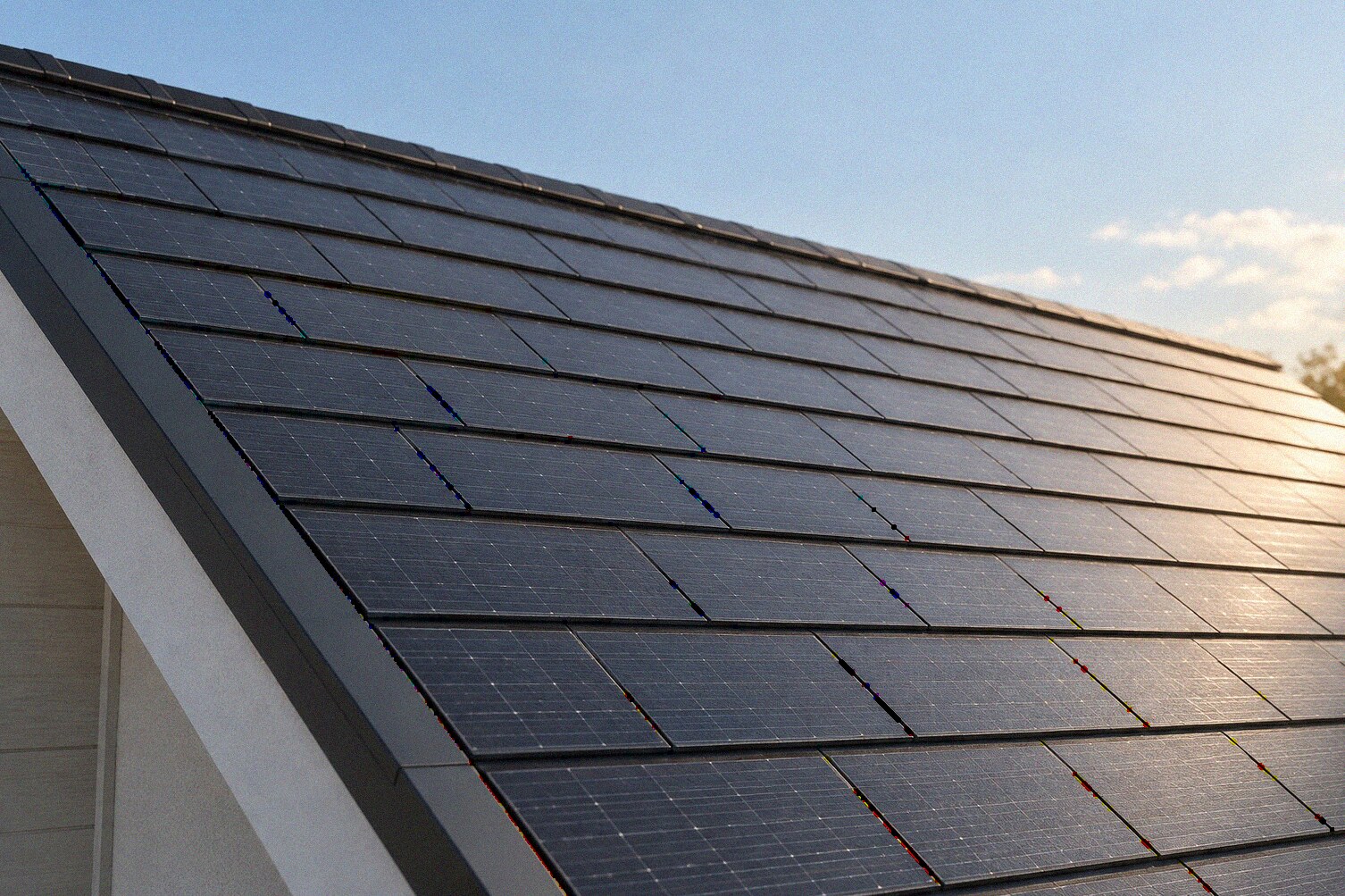 Illustration of photovoltaic shingles integrated into a sloping roof.